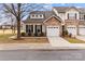 Attractive home exterior with stone accents, a two-car garage, and tasteful landscaping at 8412 Brookings Dr, Charlotte, NC 28269