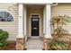 Charming front entrance with a black door, stone accents, and well-maintained landscaping at 8412 Brookings Dr, Charlotte, NC 28269