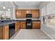 Functional kitchen features wooden cabinetry, granite countertops, and stainless steel appliances at 8412 Brookings Dr, Charlotte, NC 28269