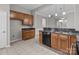 Well-equipped kitchen featuring granite countertops, wood cabinets, and open access to other rooms at 8412 Brookings Dr, Charlotte, NC 28269