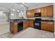 Eat-in kitchen features wood cabinets, granite countertops, and black appliances at 8412 Brookings Dr, Charlotte, NC 28269