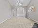 Expansive living room with open layout and neutral finishes, featuring views to the entrance and an arched window at 8412 Brookings Dr, Charlotte, NC 28269