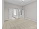 Spacious primary bedroom with neutral carpet and ensuite bathroom at 8412 Brookings Dr, Charlotte, NC 28269