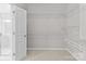 Well-organized walk-in closet with wire shelving, conveniently located next to a modern bathroom at 8412 Brookings Dr, Charlotte, NC 28269