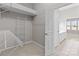 Spacious walk-in closet with wire shelving, adjacent to a bright bathroom with double sinks at 8412 Brookings Dr, Charlotte, NC 28269