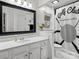 Bathroom with white vanity, black framed mirror, and shower with unique shower curtain at 9904 Duane Ct, Huntersville, NC 28078