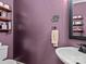 Stylish powder room featuring a modern vanity, toilet, and decorative accents at 9904 Duane Ct, Huntersville, NC 28078