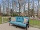 Relax on this spacious deck with a comfortable blue cushioned couch and enjoy the wooded backyard view at 9904 Duane Ct, Huntersville, NC 28078