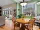 Cozy dining area with hardwood floors, a wooden table and chairs, and a large window overlooking the backyard at 9904 Duane Ct, Huntersville, NC 28078