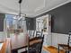 Stylish dining room featuring modern lighting, chair railing, and a spacious table at 9904 Duane Ct, Huntersville, NC 28078