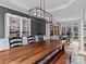 Open dining room with hardwood floors, modern lighting, and built-in cabinets at 9904 Duane Ct, Huntersville, NC 28078