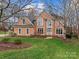 Charming brick home featuring a well-manicured lawn, large windows, and a welcoming front entrance at 9904 Duane Ct, Huntersville, NC 28078