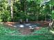 A backyard fire pit offers a cozy and inviting space for outdoor gatherings surrounded by trees at 9904 Duane Ct, Huntersville, NC 28078
