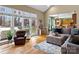 Open concept living room with hardwood floors, a large sectional sofa, and a view to the patio at 9904 Duane Ct, Huntersville, NC 28078