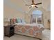 Serene main bedroom with a tray ceiling, large windows, a comfortable bed, and a bedside table at 9904 Duane Ct, Huntersville, NC 28078
