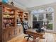 Bright office featuring custom built-in shelves, hardwood floors, and lots of natural light at 9904 Duane Ct, Huntersville, NC 28078