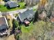 Spacious home nestled in a neighborhood, featuring mature trees, a backyard patio, and an expansive lawn at 11000 King George Ln, Waxhaw, NC 28173