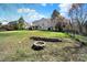Spacious backyard features a fire pit and is surrounded by mature trees at 11000 King George Ln, Waxhaw, NC 28173