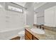 Bright bathroom featuring a bathtub, shower, vanity with granite countertop and wood cabinets at 11000 King George Ln, Waxhaw, NC 28173