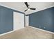 Neutral bedroom features a ceiling fan and closet with double doors at 11000 King George Ln, Waxhaw, NC 28173
