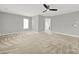 Bright bedroom with neutral walls, carpet, a ceiling fan, and a view into the ensuite bathroom at 11000 King George Ln, Waxhaw, NC 28173
