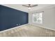 Comfortable bedroom with blue accent wall, neutral carpeting, and a large window at 11000 King George Ln, Waxhaw, NC 28173