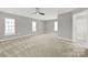 Spacious bedroom featuring plush carpeting, neutral paint, ceiling fan, and natural light at 11000 King George Ln, Waxhaw, NC 28173