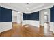 Spacious formal dining room featuring wainscoting, and hardwood flooring at 11000 King George Ln, Waxhaw, NC 28173