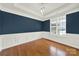 Elegant dining room with wood floors, wainscoting, and ample natural light at 11000 King George Ln, Waxhaw, NC 28173