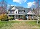 Charming two-story brick home with manicured lawn and mature landscaping at 11000 King George Ln, Waxhaw, NC 28173