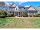 Attractive two-story brick home with manicured landscaping and a welcoming front porch at 11000 King George Ln, Waxhaw, NC 28173