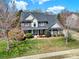 Classic two-story brick home with a manicured lawn and inviting curb appeal on a bright day at 11000 King George Ln, Waxhaw, NC 28173