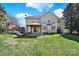 Two-story home has a covered patio, grassy yard and mature trees at 11000 King George Ln, Waxhaw, NC 28173