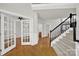 Inviting foyer featuring hardwood floors and a staircase at 11000 King George Ln, Waxhaw, NC 28173