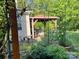 Secluded outdoor space featuring a covered gazebo with comfortable seating and a charming garden setting at 11000 King George Ln, Waxhaw, NC 28173