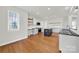Bright kitchen featuring white cabinets, a kitchen island, stainless steel appliances, and hardwood floors at 11000 King George Ln, Waxhaw, NC 28173