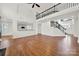 Open floor plan featuring hardwood floors, view of the staircase and connection to the kitchen at 11000 King George Ln, Waxhaw, NC 28173