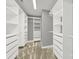 Organized walk-in closet with built-in shelving and drawers, offering ample storage space at 11000 King George Ln, Waxhaw, NC 28173