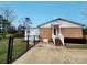 Fenced backyard with a brick and white house, featuring a concrete patio at 114 Eller Rd, Gastonia, NC 28056
