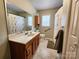 Neutral bathroom featuring a vanity, large mirror, and shower with floral curtain at 114 Eller Rd, Gastonia, NC 28056
