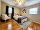 Bright bedroom with hardwood floors, ceiling fan, and a cozy chair by the window at 114 Eller Rd, Gastonia, NC 28056