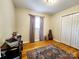 Well-lit bedroom featuring hardwood floors, a window with curtains, and a closet at 114 Eller Rd, Gastonia, NC 28056