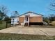 Rear view of a well-maintained home featuring a fenced yard and patio at 114 Eller Rd, Gastonia, NC 28056