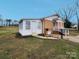 Exterior view of a home with fenced-in yard and white sunroom at 114 Eller Rd, Gastonia, NC 28056