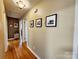 Hallway with hardwood floors and decorative pictures on the wall at 114 Eller Rd, Gastonia, NC 28056