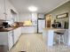 Practical kitchen featuring white cabinets, wood countertops, and tile flooring at 114 Eller Rd, Gastonia, NC 28056
