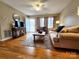 Inviting living room features hardwood floors, ceiling fan, and comfortable furnishings at 114 Eller Rd, Gastonia, NC 28056
