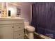 Updated bathroom with a modern vanity, toilet, and shower with purple curtain at 115 Setter Ct, Statesville, NC 28625