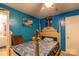 Cozy bedroom with blue walls, decorative artwork, and a comfortable-looking bed at 115 Setter Ct, Statesville, NC 28625