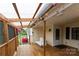 Bright covered porch featuring a swing, wood flooring, and cheerful decorations for enjoyable outdoor living at 115 Setter Ct, Statesville, NC 28625